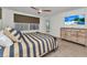 Bright bedroom features stylish striped bedding, a ceiling fan, and access to the outdoors at 125 Donna Ct, Punta Gorda, FL 33950