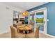 Cozy dining area with a unique table, stylish chairs, and natural lighting from sliding glass doors at 125 Donna Ct, Punta Gorda, FL 33950