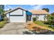 Well-maintained single-story home with attached garage and landscaped front yard, showcasing its curb appeal at 125 Donna Ct, Punta Gorda, FL 33950