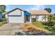 Charming single-story home featuring a well-manicured lawn, and a driveway leading to an attached garage at 125 Donna Ct, Punta Gorda, FL 33950