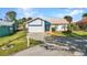 Single-story home features well-kept lawn, driveway, and an attached garage enhancing the property's appeal at 125 Donna Ct, Punta Gorda, FL 33950
