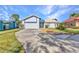 Charming single-story home with driveway, lush lawn, and attached garage on a sunny day at 125 Donna Ct, Punta Gorda, FL 33950