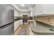 Well-lit kitchen featuring white cabinets, stainless steel appliances, and stylish countertops at 125 Donna Ct, Punta Gorda, FL 33950