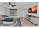 Bright living room featuring a sofa, armchair, and a large screen television with a tropical view at 125 Donna Ct, Punta Gorda, FL 33950