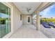 Covered patio features tile flooring, ceiling fan, and sliding glass doors to the pool at 125 Donna Ct, Punta Gorda, FL 33950