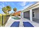 Backyard pool with paver deck, metal grab rail, mature palm trees, and covered patio at 125 Donna Ct, Punta Gorda, FL 33950