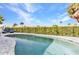 Inviting pool area featuring tropical landscaping, clear blue water, and comfortable lounge chairs at 125 Donna Ct, Punta Gorda, FL 33950