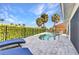 Backyard pool area featuring a kidney-shaped pool, lounge chairs, and tropical landscaping at 125 Donna Ct, Punta Gorda, FL 33950