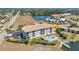 Aerial view of condo community with pool, water access, and lush landscaping at 1349 Aqui Esta Dr # 121, Punta Gorda, FL 33950