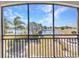Screened-in balcony with serene views of the waterfront and lush greenery at 1349 Aqui Esta Dr # 121, Punta Gorda, FL 33950