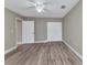 Bedroom featuring neutral walls, hardwood floors, ceiling fan and double door closet at 1349 Aqui Esta Dr # 121, Punta Gorda, FL 33950