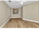 Comfortable bedroom with hardwood floors, a ceiling fan, and a window with natural light at 1349 Aqui Esta Dr # 121, Punta Gorda, FL 33950