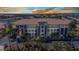 Elegant condominium building featuring multiple stories and picturesque balconies overlooking lush landscaping at 1349 Aqui Esta Dr # 121, Punta Gorda, FL 33950