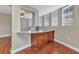 Kitchenette area with granite countertops, wooden cabinetry, and natural light from the windows at 1349 Aqui Esta Dr # 121, Punta Gorda, FL 33950