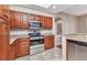 Well-equipped kitchen featuring stainless steel appliances and cherry cabinets at 1349 Aqui Esta Dr # 121, Punta Gorda, FL 33950