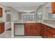 An open concept kitchen boasts granite countertops and stainless steel dishwasher at 1349 Aqui Esta Dr # 121, Punta Gorda, FL 33950
