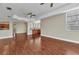 Open-concept living space with rich wood floors, tray ceilings, and a kitchen area at 1349 Aqui Esta Dr # 121, Punta Gorda, FL 33950