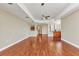 Spacious living area featuring tray ceilings, wood floors, and a glimpse of the kitchen at 1349 Aqui Esta Dr # 121, Punta Gorda, FL 33950