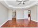 Spacious main bedroom with hardwood floors, ceiling fan, and walk-in bathroom at 1349 Aqui Esta Dr # 121, Punta Gorda, FL 33950