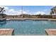 Inviting in-ground community pool with brick trim and relaxing lounge chairs nearby at 1349 Aqui Esta Dr # 121, Punta Gorda, FL 33950
