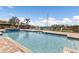 Community swimming pool surrounded by brick pavers with views of the waterway at 1349 Aqui Esta Dr # 121, Punta Gorda, FL 33950