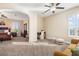 Spacious bedroom with neutral tones, ceiling fans, great natural light, and seating area at 14142 Fort Myers Ave, Port Charlotte, FL 33981
