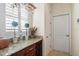 Granite countertop in butler's pantry with wooden cabinets and wine rack at 14142 Fort Myers Ave, Port Charlotte, FL 33981