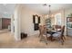 Charming dining room with rattan chairs, tile floors, and decorative shutter accent at 14142 Fort Myers Ave, Port Charlotte, FL 33981