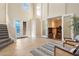 Bright foyer with tile floors, staircase, and glass double doors to office space provides an inviting entrance at 14142 Fort Myers Ave, Port Charlotte, FL 33981