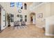 Spacious foyer featuring travertine floors, staircase, and large windows allows natural light to illuminate the space at 14142 Fort Myers Ave, Port Charlotte, FL 33981