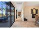 Hallway features travertine flooring, exterior spiral staircase, and large sliding glass doors to outdoor area at 14142 Fort Myers Ave, Port Charlotte, FL 33981