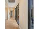 Hallway with travertine flooring and arched entryways with large slider leading to outdoor patio at 14142 Fort Myers Ave, Port Charlotte, FL 33981