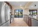 Open kitchen with granite countertops, stainless appliances, and backyard view at 14142 Fort Myers Ave, Port Charlotte, FL 33981