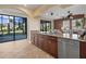 Open kitchen features a granite island and countertops, seamlessly connects to the outdoor living areas at 14142 Fort Myers Ave, Port Charlotte, FL 33981