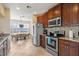 Well-lit kitchen with stainless steel appliances, granite counters, and a cozy breakfast nook at 14142 Fort Myers Ave, Port Charlotte, FL 33981