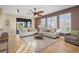 Open-concept living room featuring neutral tones, comfortable seating, and seamless access to outdoor spaces at 14142 Fort Myers Ave, Port Charlotte, FL 33981