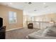 Upstairs loft area with neutral carpet, sofa, and window, creating a comfortable space at 14142 Fort Myers Ave, Port Charlotte, FL 33981