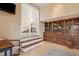 Home office featuring a built-in wooden bookcase and staircase entrance to the home's open floor plan at 14142 Fort Myers Ave, Port Charlotte, FL 33981