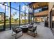 Screened patio with spiral staircase, seating area, and views of the surrounding landscape at 14142 Fort Myers Ave, Port Charlotte, FL 33981
