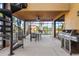 Outdoor patio area with spiral staircase, table, grill, and clear views of the pool at 14142 Fort Myers Ave, Port Charlotte, FL 33981