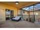Covered porch with seating and views of the courtyard area with spiral staircase access at 14142 Fort Myers Ave, Port Charlotte, FL 33981