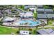 Aerial view showcases the pool, tennis courts, clubhouse, and parking at 14224 Heritage Landing Blvd # 923, Punta Gorda, FL 33955