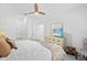 A neutral bedroom with a ceiling fan, a dresser with a TV and chair at 14224 Heritage Landing Blvd # 923, Punta Gorda, FL 33955