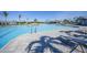 Large community pool with clear water, lounge chairs, and a surrounding brick patio at 14224 Heritage Landing Blvd # 923, Punta Gorda, FL 33955