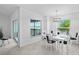 Comfortable dining area with a set table, slider doors to the patio, a bright window, and an overhead light fixture at 14224 Heritage Landing Blvd # 923, Punta Gorda, FL 33955