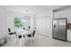 Inviting dining room featuring a table set for six, with a view from the window, plus a stainless steel refrigerator at 14224 Heritage Landing Blvd # 923, Punta Gorda, FL 33955