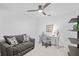 Comfortable home office with a gray sofa, desk and chair, decorative accents, and a large window for natural light at 14224 Heritage Landing Blvd # 923, Punta Gorda, FL 33955