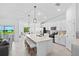 Well-lit kitchen with white cabinetry, stainless steel appliances, a center island with seating, and an adjacent dining area at 14224 Heritage Landing Blvd # 923, Punta Gorda, FL 33955