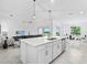 Open-concept kitchen with an island connecting to the living and dining areas, offering views from the sliding glass doors at 14224 Heritage Landing Blvd # 923, Punta Gorda, FL 33955