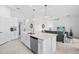 Modern kitchen showcasing a large island with a sink and dishwasher, open to a living room with a gray sofa and a TV at 14224 Heritage Landing Blvd # 923, Punta Gorda, FL 33955